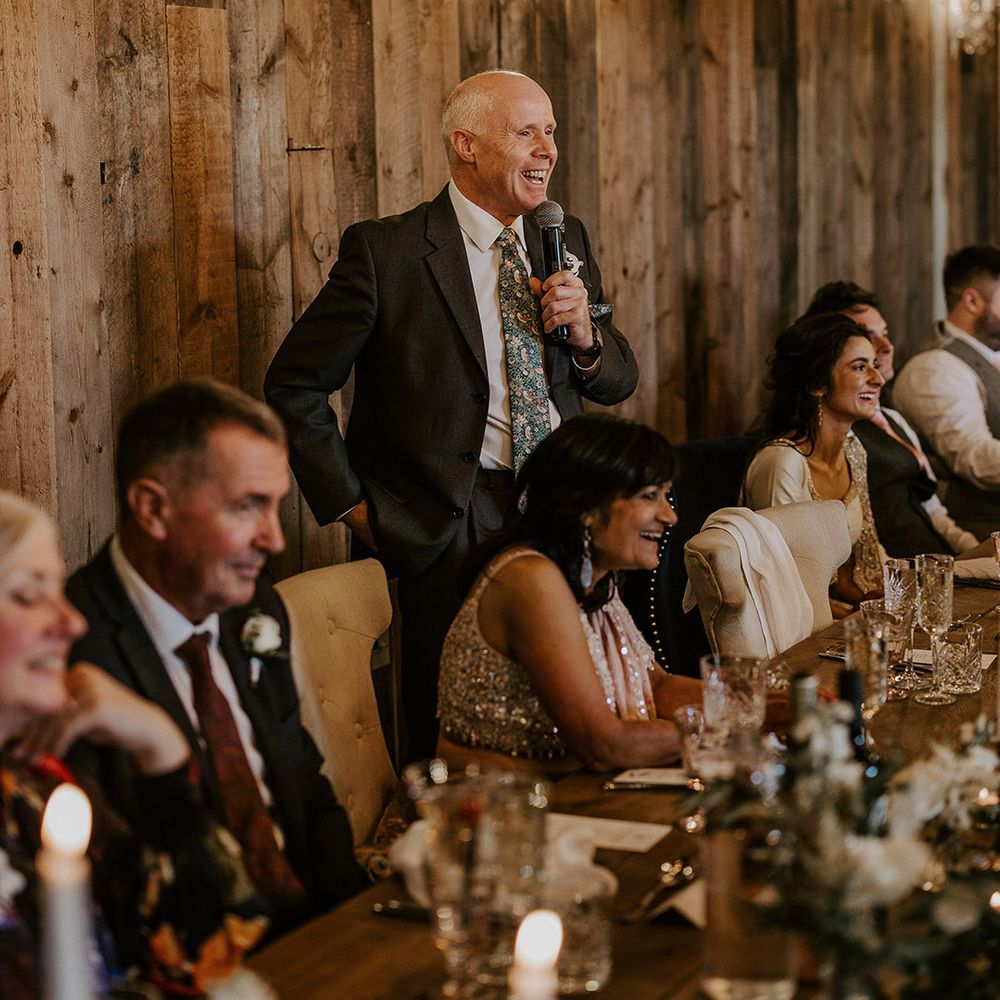 Father of the bride reads out his wedding speech to the guests 