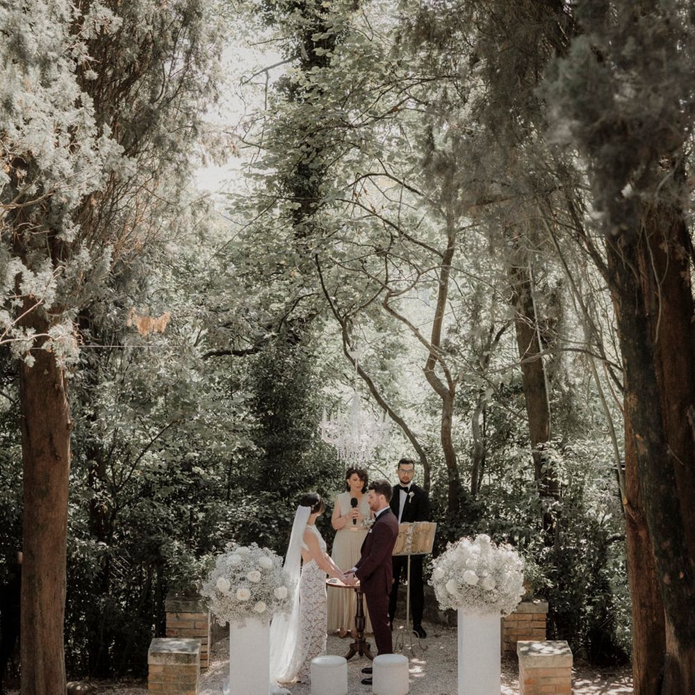 Outdoor wedding ceremony at Italian villa with white flower decorations 