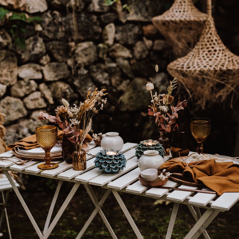 Outdoor table setting with wicker lampshades hanging