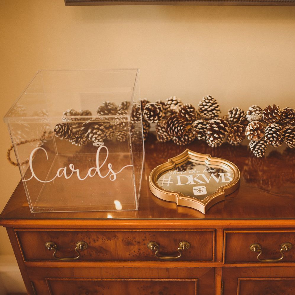 Wedding guest book and card table decorated with pinecones 