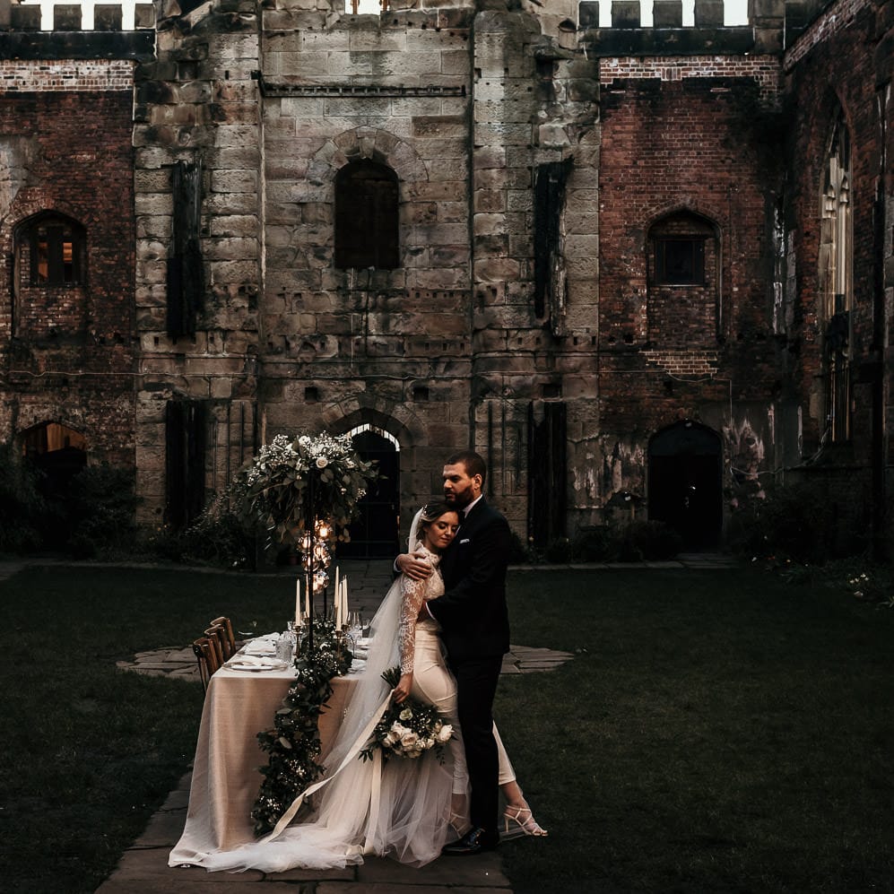 Unique bombed out church wedding venue in Liverpool with intimate wedding reception table 