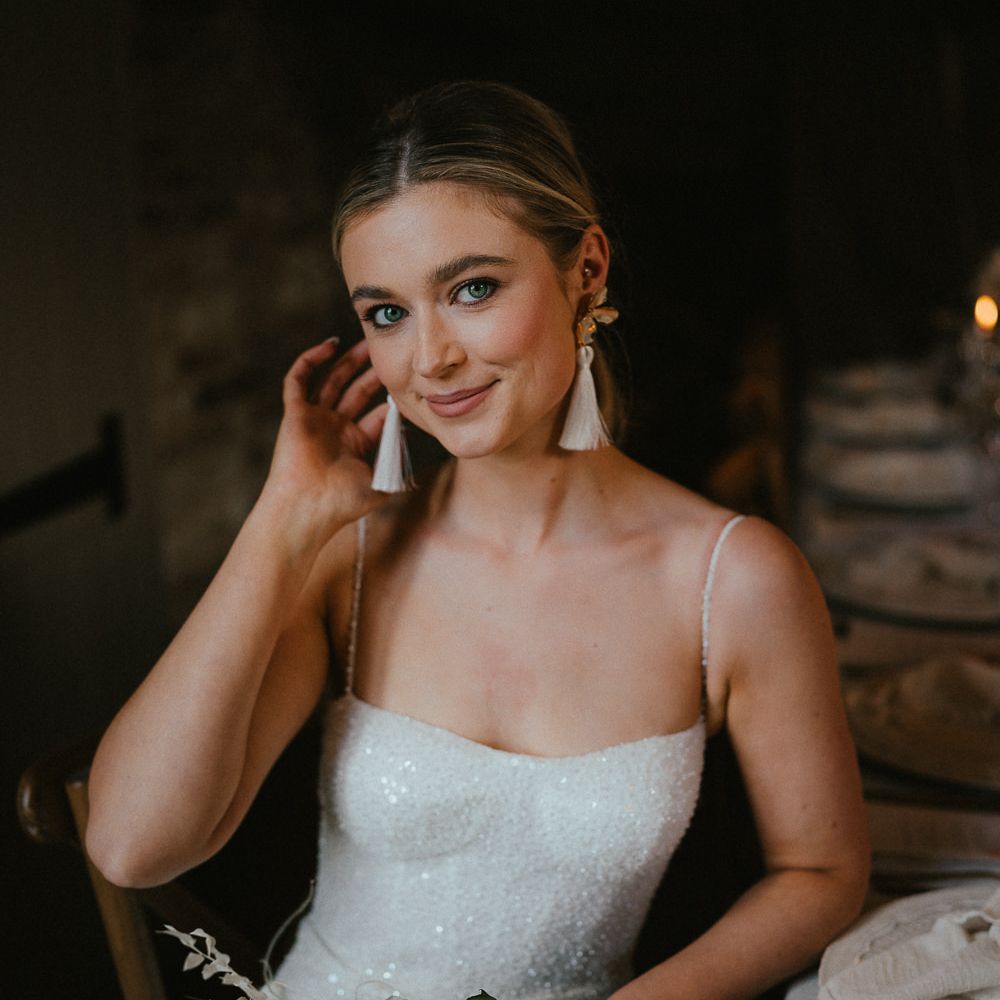Bride in a sparkly wedding dress with tassel earrings 