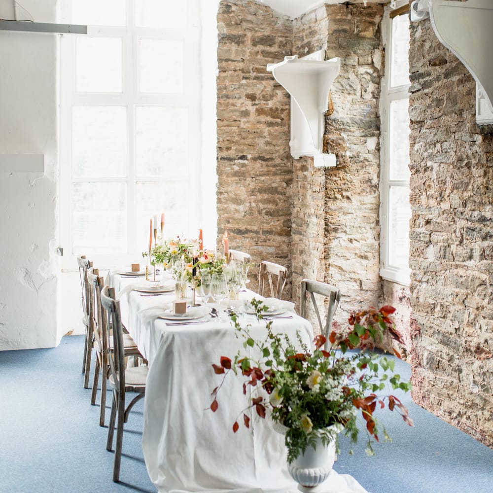 Elegant tablescape at Torr Vale Mill with exposed brick wall 