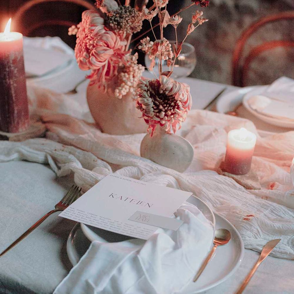 Place setting with fabric table runner, pillar candles, dried flower centrepieces and modern on the day stationery 