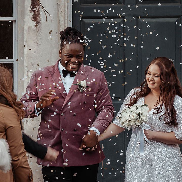 Bride & groom leave ceremony as wedding guests throw confetti around them