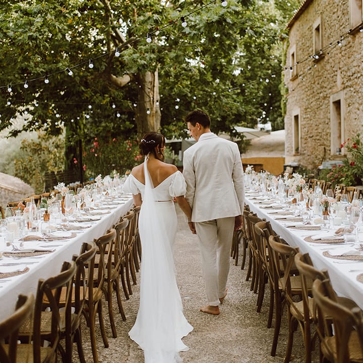 Bride and groom walk in the reception area 