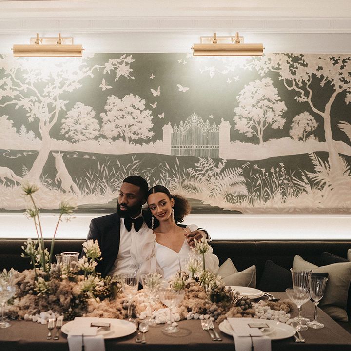 Intimate wedding reception at Mayfair Townhouse with green and white wedding flowers 