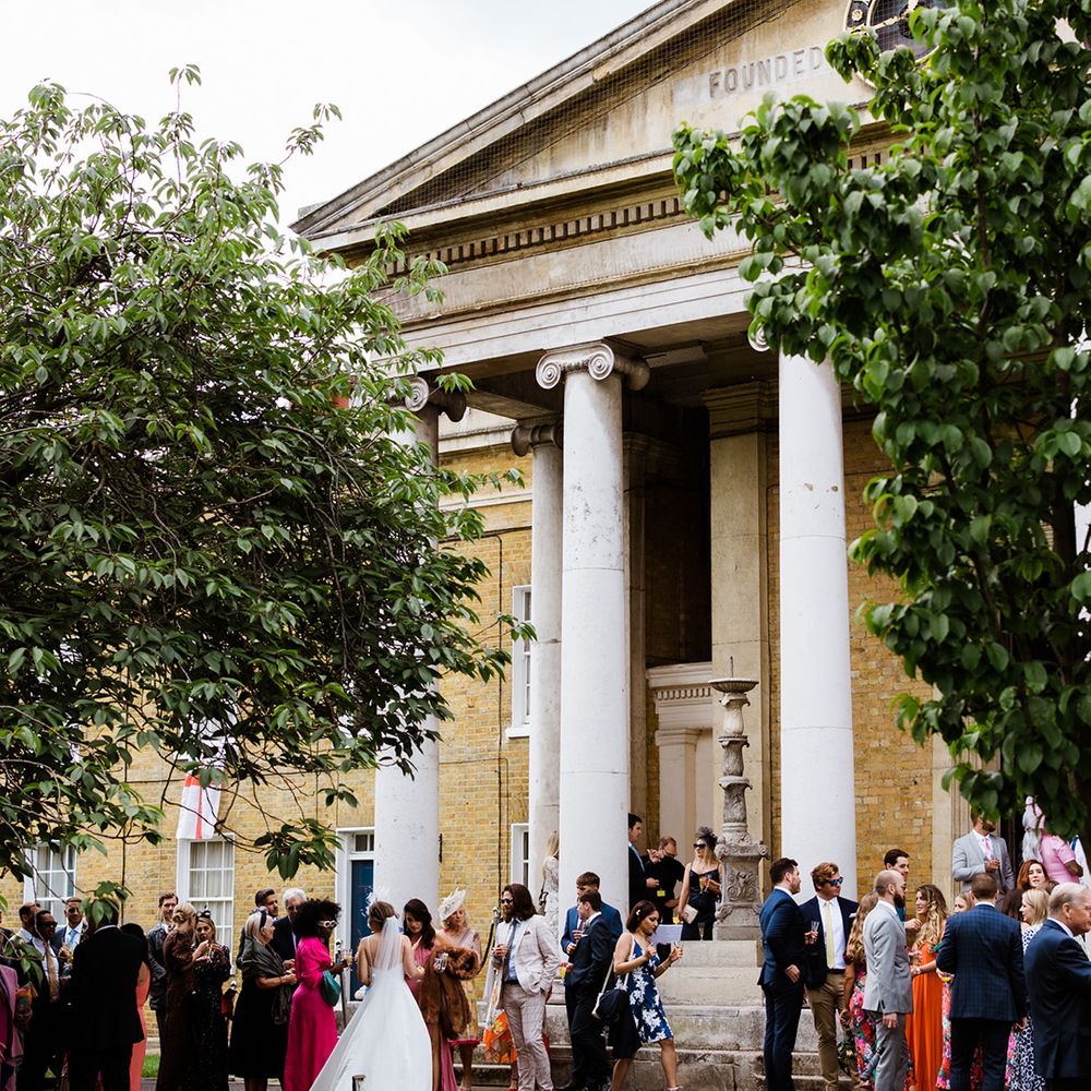 Wedding party outside of wedding venue in London for summer wedding