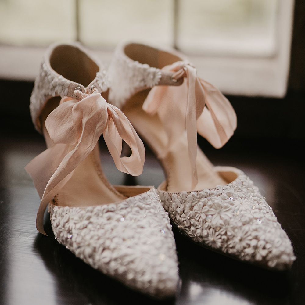 Wedding shoes with tiny flowers and pink ribbon 