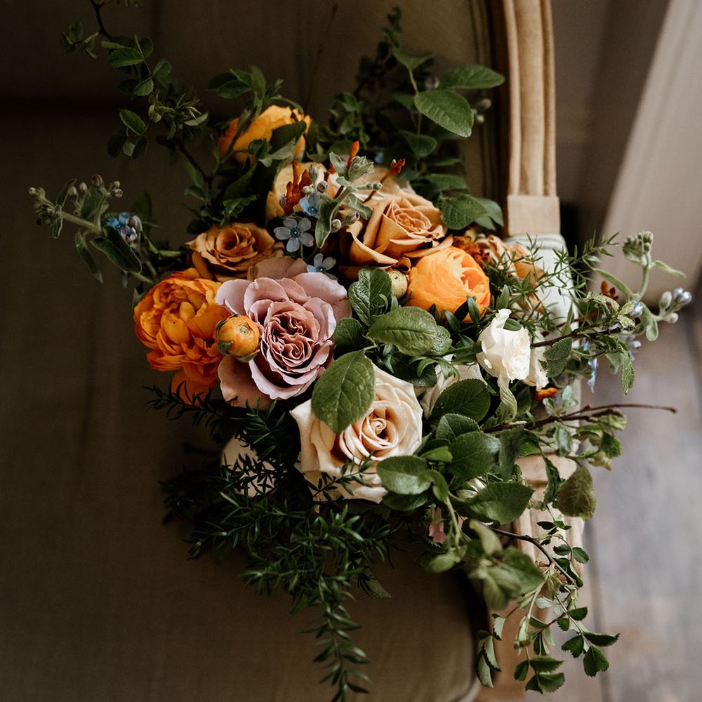 Bridal bouquet with blue, orange, yellow and pink flowers 