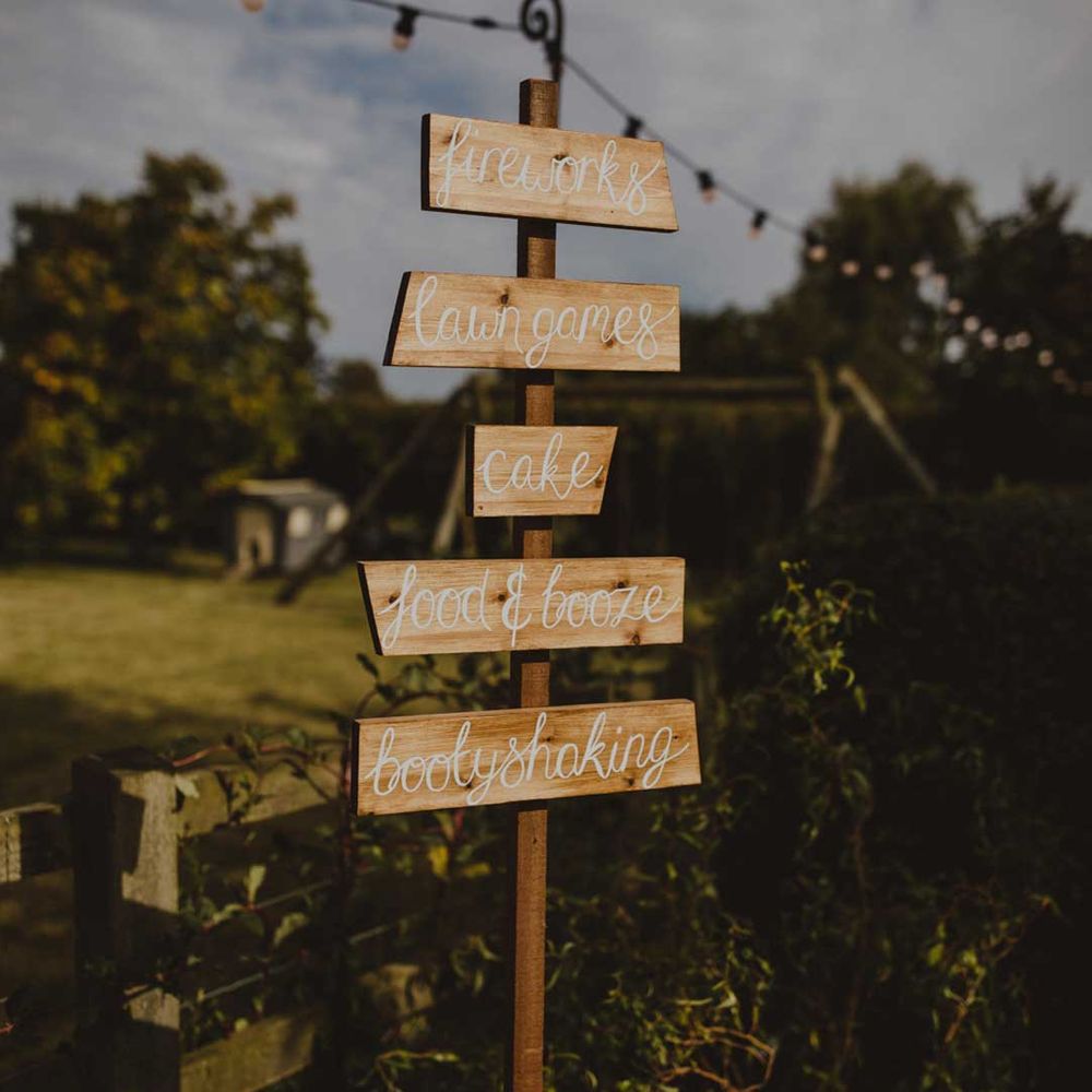 DIY wooden wedding sign at outdoor wedding