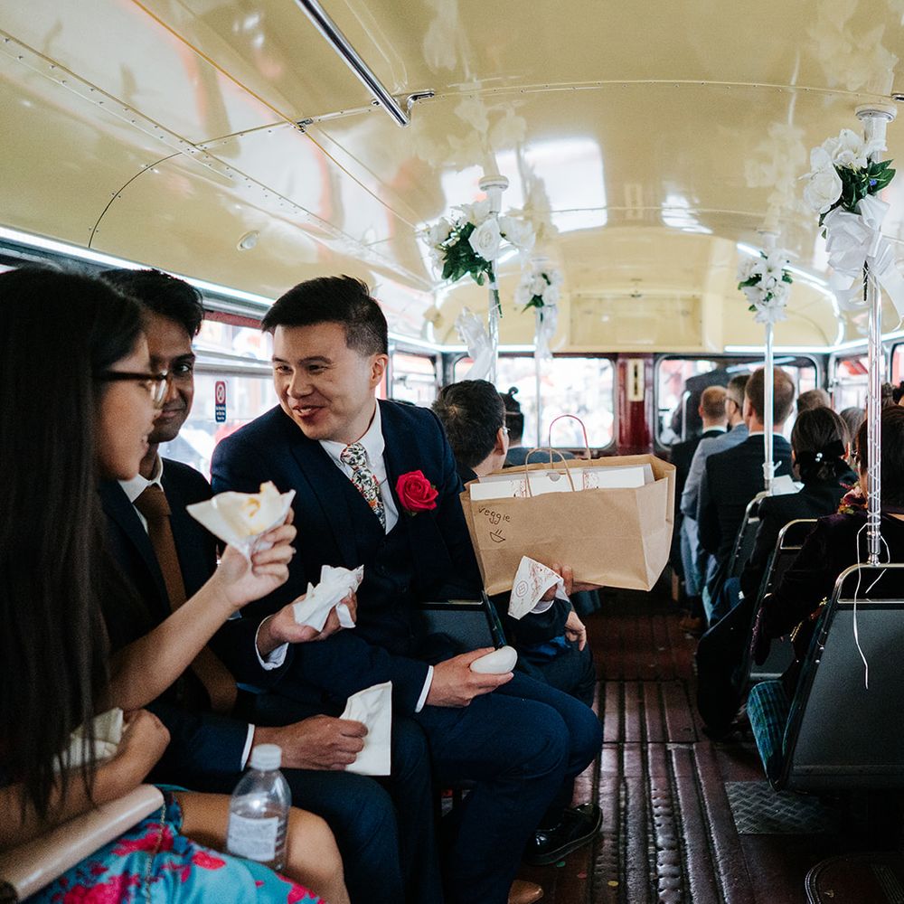 Wedding guests gather in London bus after wedding ceremony