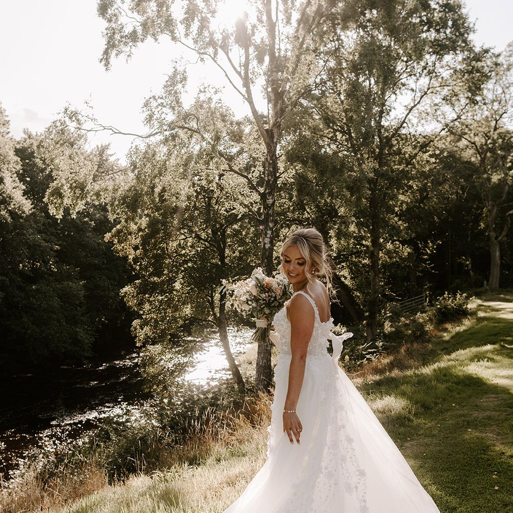 The bride in a princess Eleganza Sposa Iconica wedding dress with applique and detachable skirt 