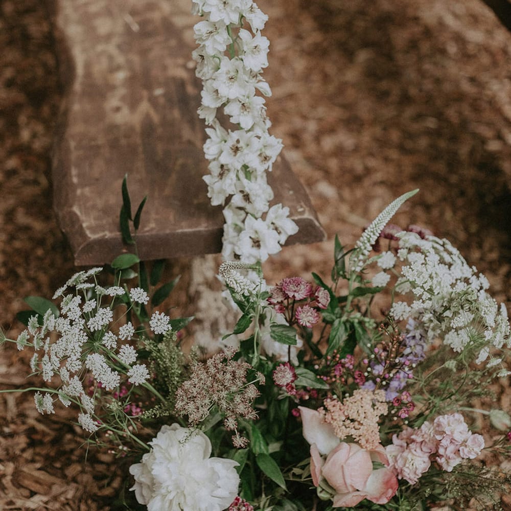 Outdoor wedding with pink and white wildflower aisle decoration 