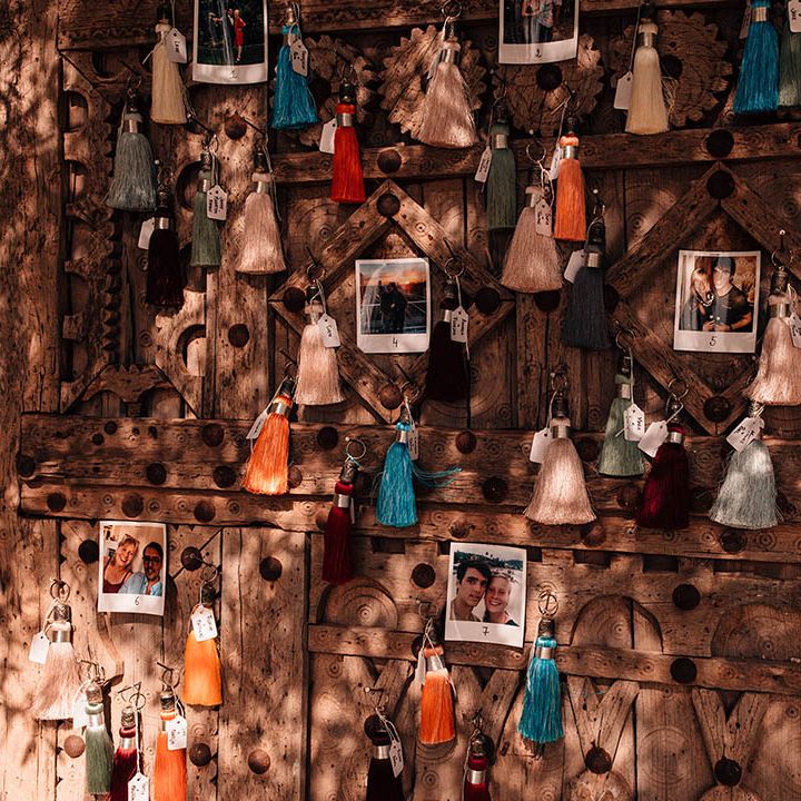 Colourful tassels with polaroid personal pictures decorating the wedding venue 