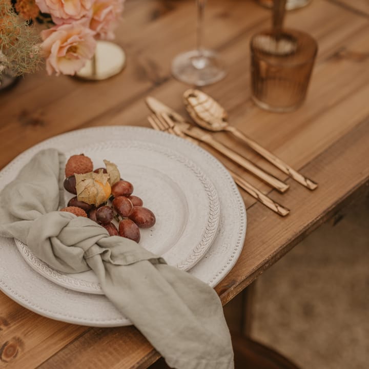 Place setting with ornate table ware, gold cutlery and fruit decor