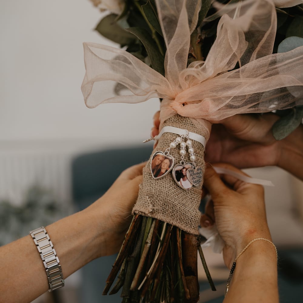 Bridal bouquet complete with white ribbon and personalised charms dangling from ribbon | Mark Bamforth Photography