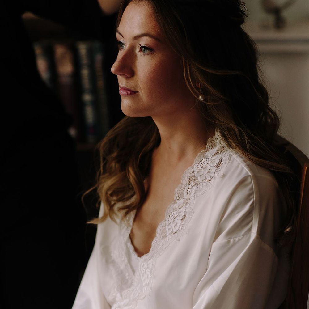 Bride in white lace getting ready robe