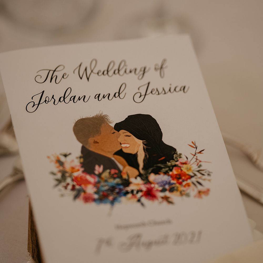 Wedding cards with personalised cartoon style drawing of the couple with floral design