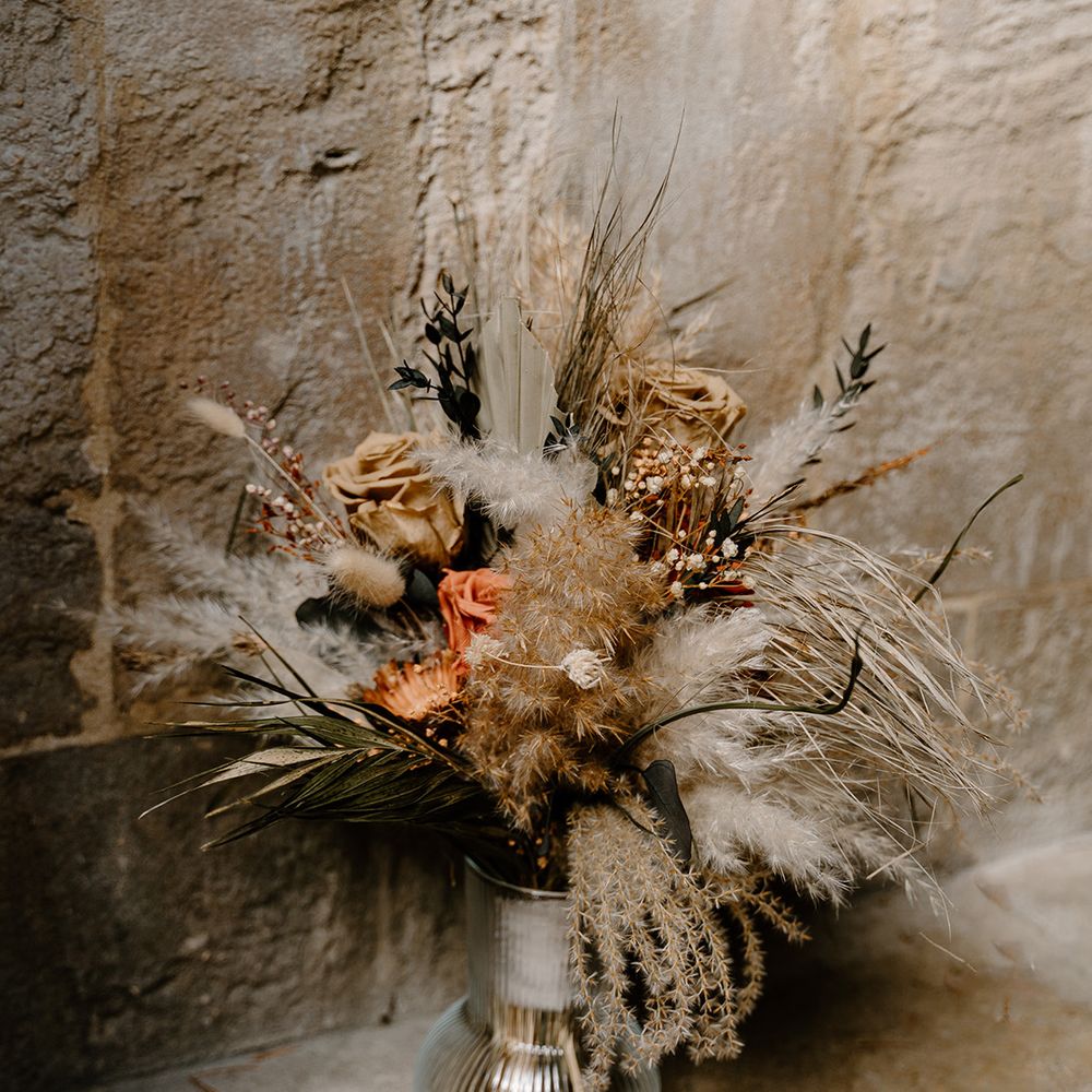 Dried flowers and roses in a glass vase for wedding decor 