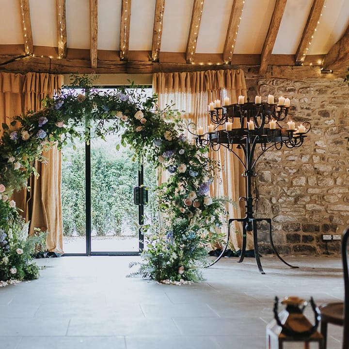wedding ceremony floral moon gate and candle altar wedding decor at Tithe Barn Bolton Abbey