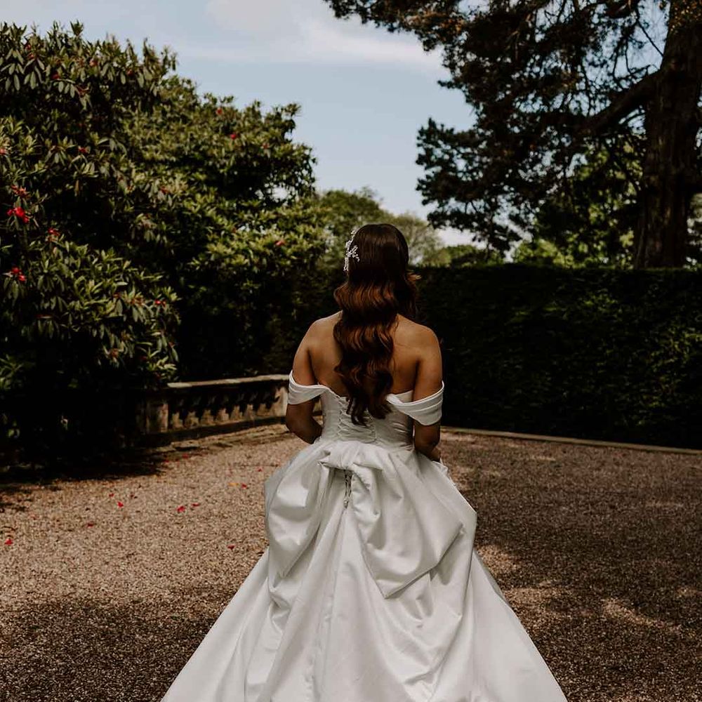 bride in a strapless wedding dress with a corset back and bow design 