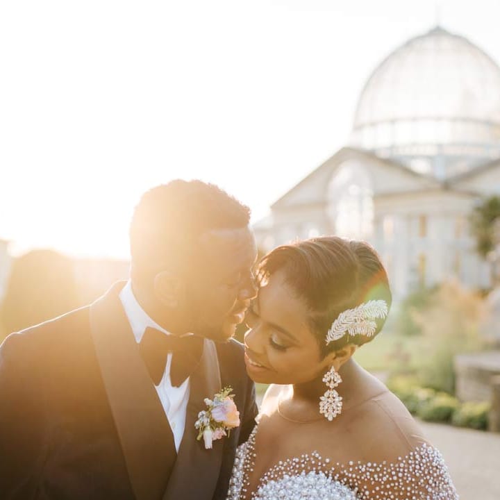 Bride and groom during golden hour standing outside of Syon Park wedding venue for their vow renewal ceremony 