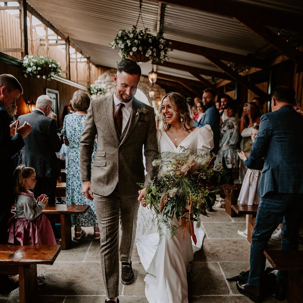 Willow Marsh Farm wedding in Loughborough with the bride and groom walking back down the aisle as a married couple 