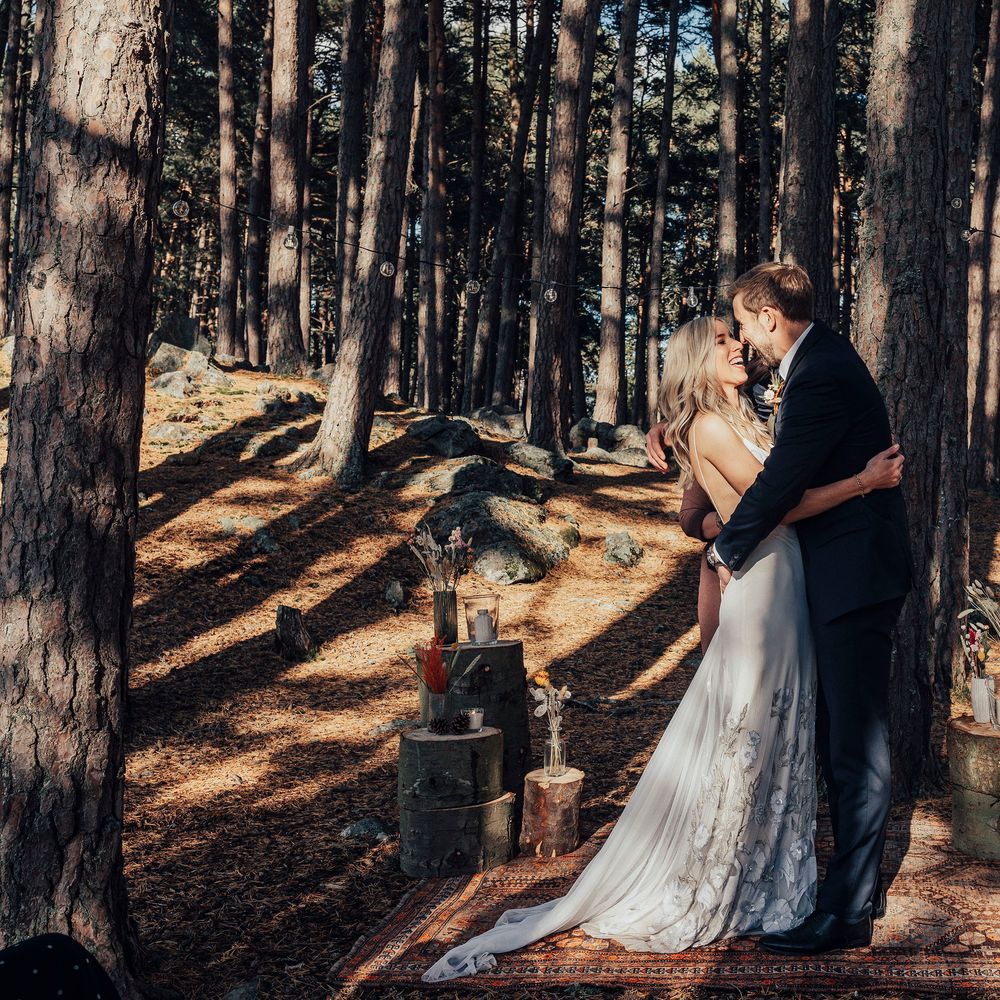 Bride & groom kiss in the woodland after wedding ceremony in Scotland