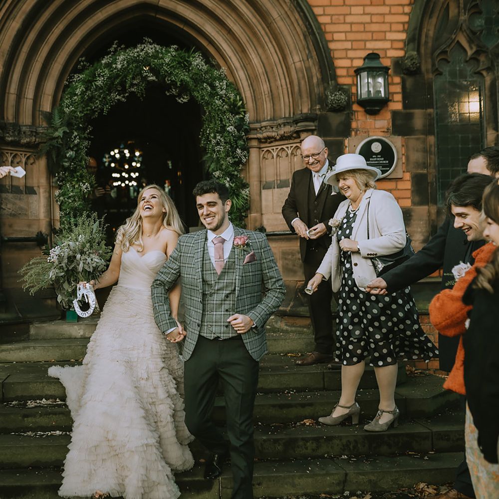Bride and groom confetti moment outside church in Liverpool