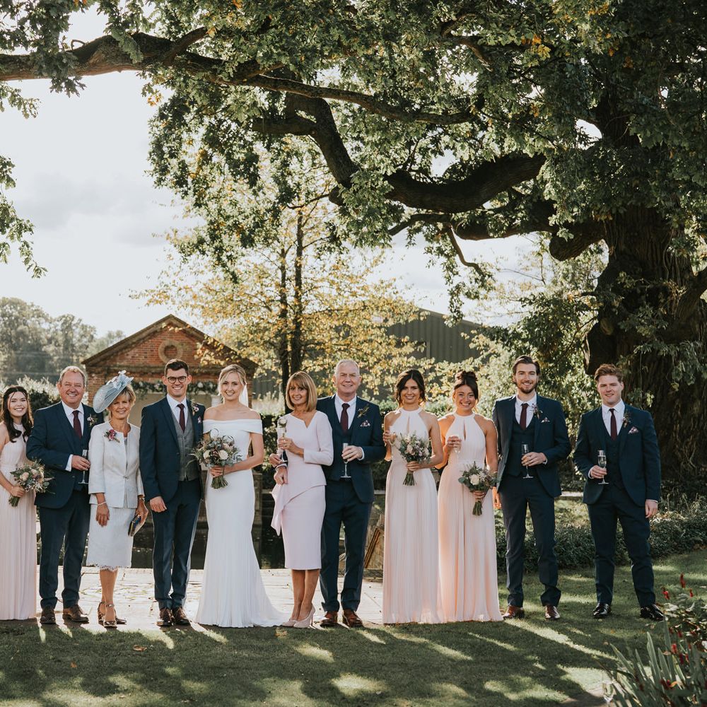 Wedding party stand together outdoors