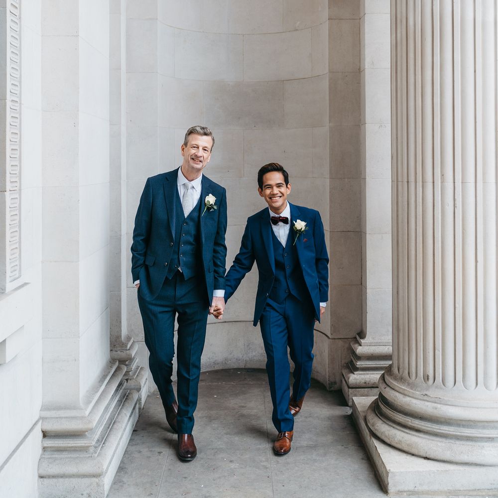 Grooms hold hands and walk together 