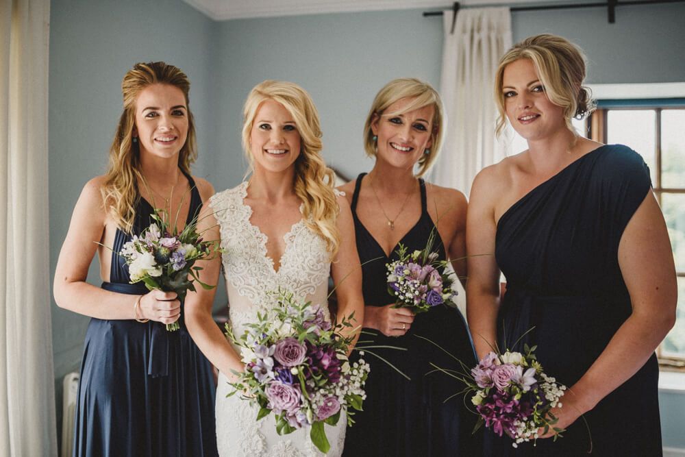 flowers to go with navy bridesmaid dresses White Rose and Astilbe Bridesmaid Bouquet with Navy Sequins Dress