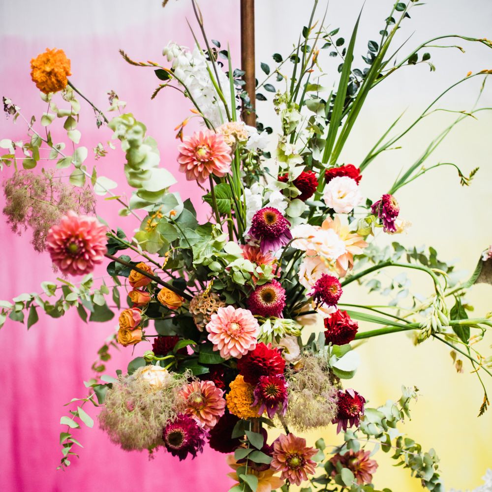Colourful wedding flower arrangement with dahlias, roses, stocks and foliage 