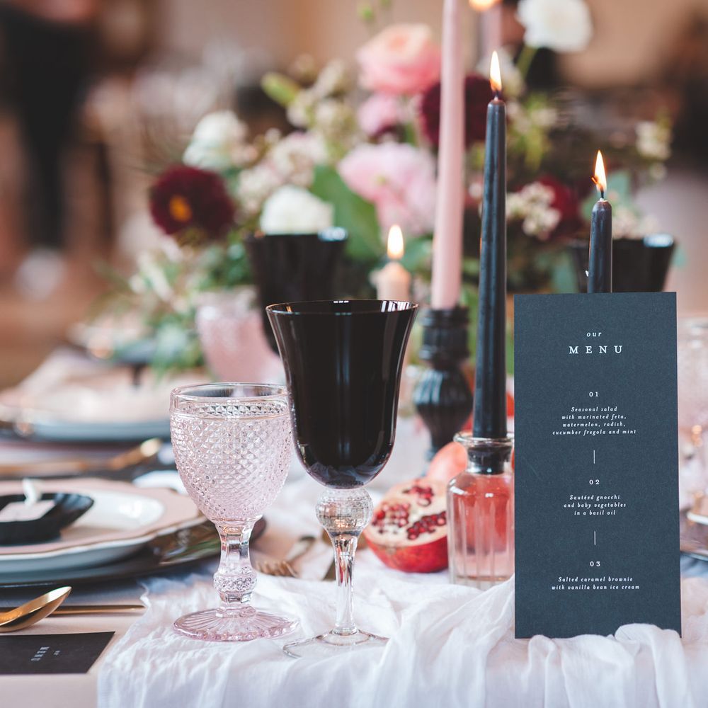 Black on the day wedding stationery menu card, taper candles and goblet table decor