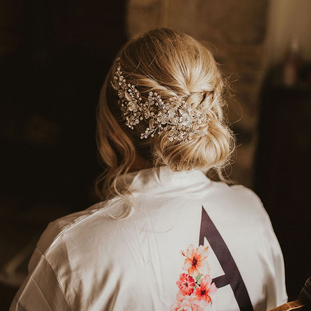Pinned bridal undo with embellished hairpiece