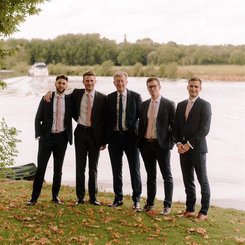 Groomsmen in matching pink ties