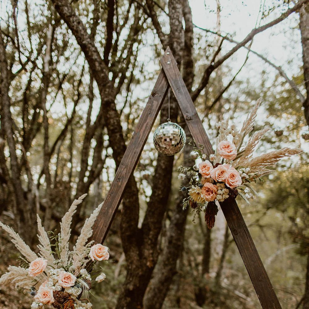 Disco ball hangs from wooden archway
