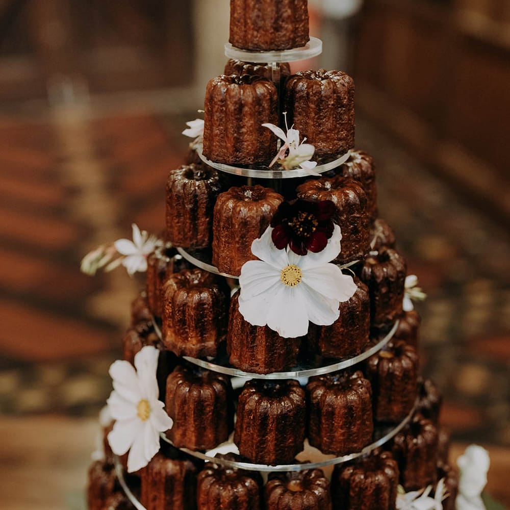 Mini bundt wedding cake on cake stand complete with floral decor 