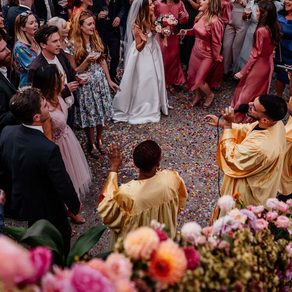 Bride, bridesmaids and wedding guests enjoying the flash mob choir wedding entertainers 