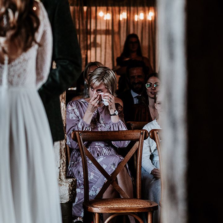 Wedding guest dries her eyes as she gets emotional over wedding ceremony 