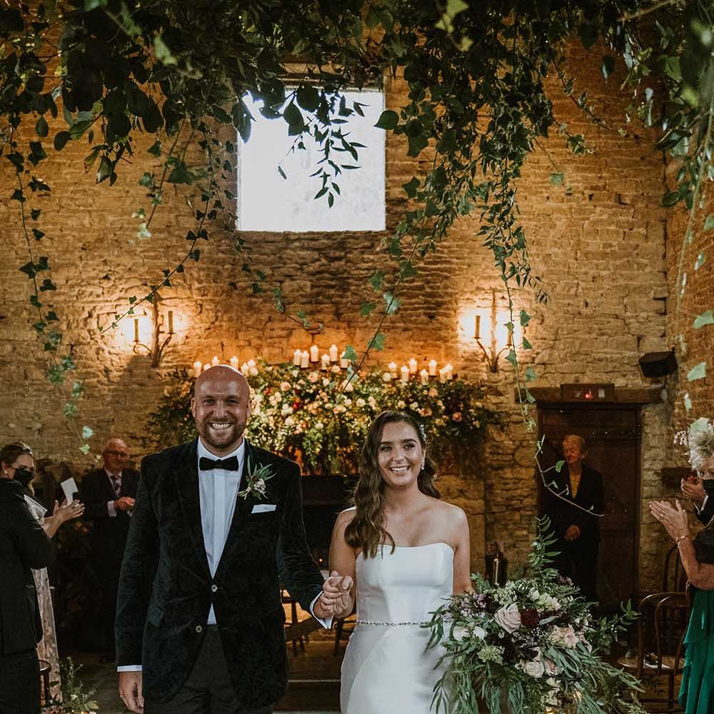 Cripps Barn civil wedding with bride in a fishtail wedding dress and natural wedding flowers 