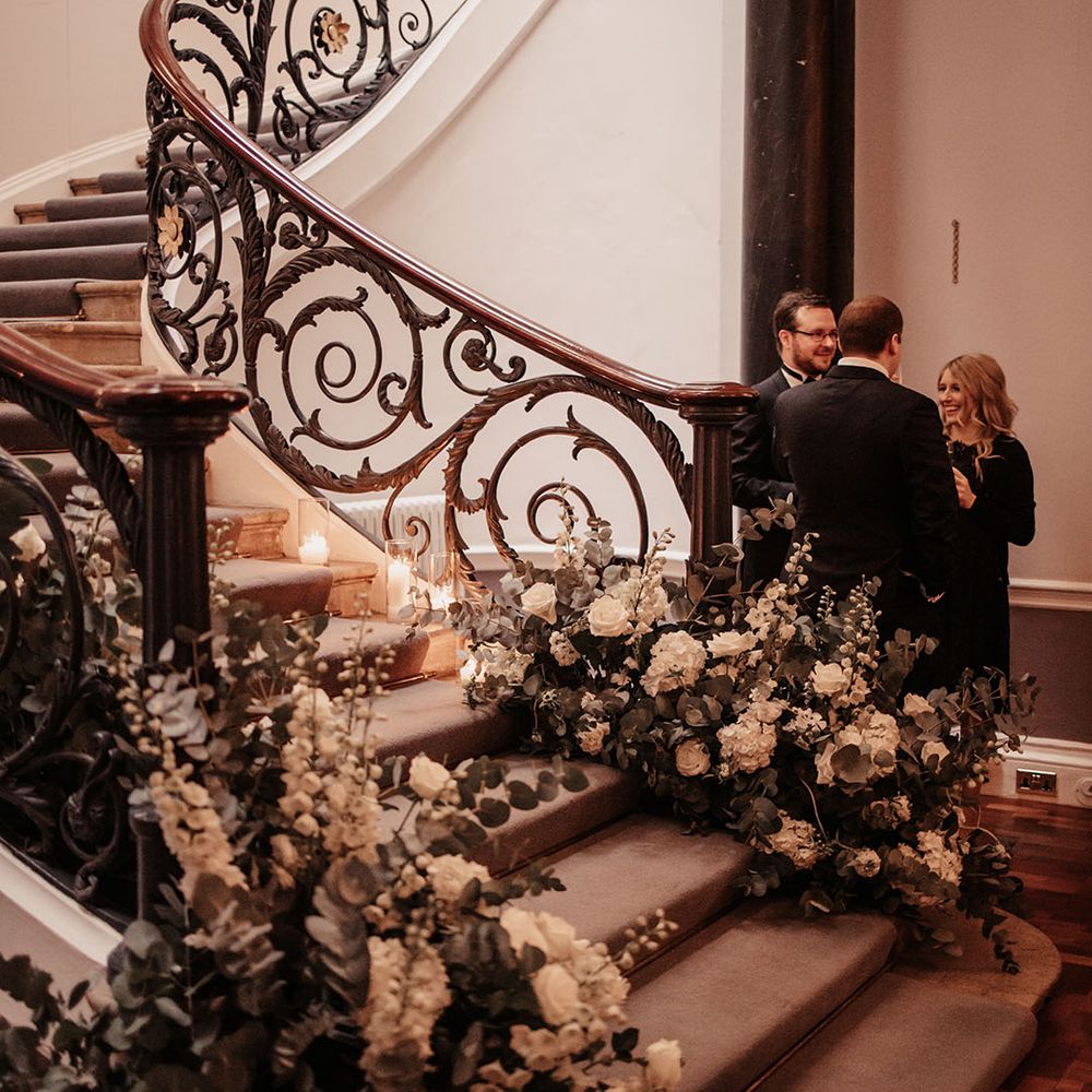 White wedding flowers and foliage decor at classic black tie wedding 