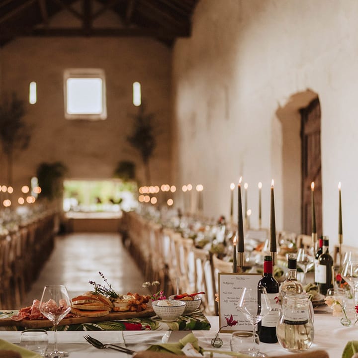 The Courtyard wedding venue in Shropshire with the tables arranged in a U shape for the wedding reception with a green theme and decor 