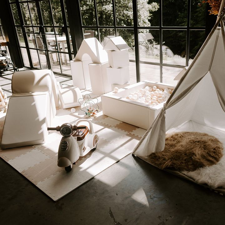 White kids soft play area with tent, ball pit and slide for children entertainment at wedding 