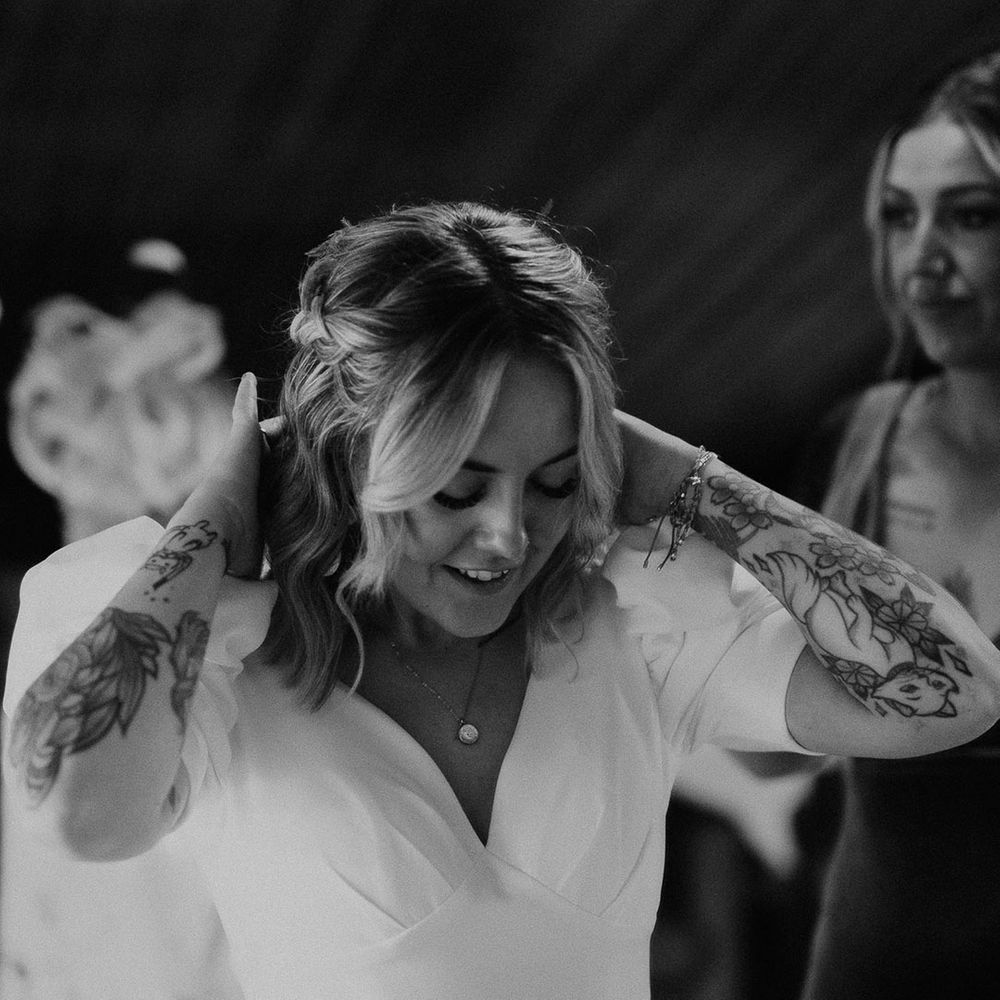 Bride in plunge fitted wedding dress getting ready for the wedding day 