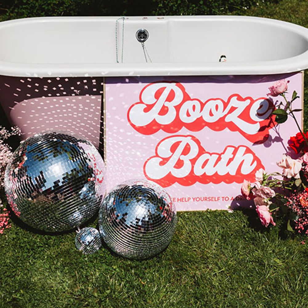 Pink booze bath wedding bar design idea with retro signage and disco balls 