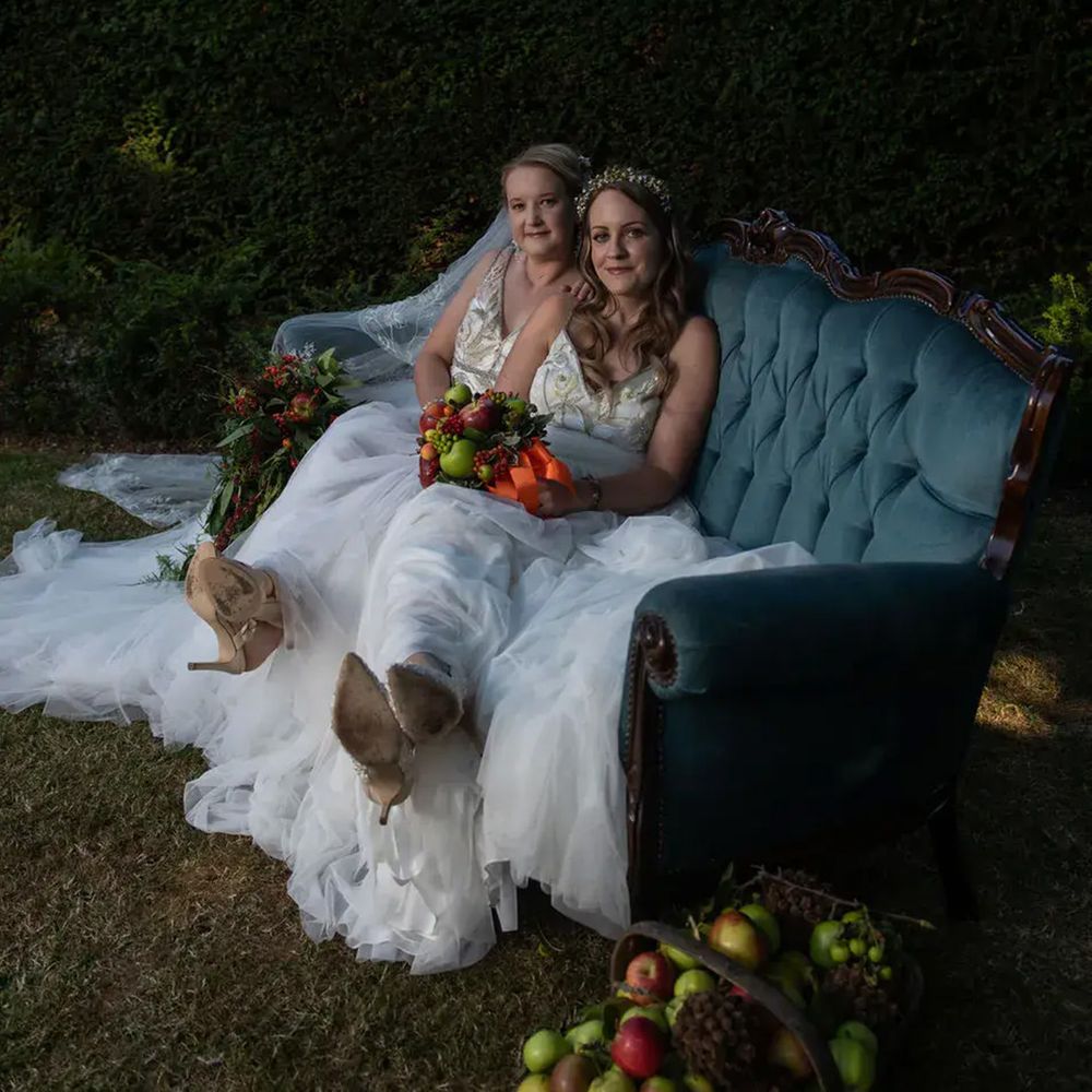 chapel-house-estate-two-brides-on-sofa