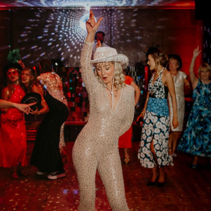Bride in Sparkly Fitted Jumpsuit with Rhinestone Cowboy Hat Wedding Reception Outfit