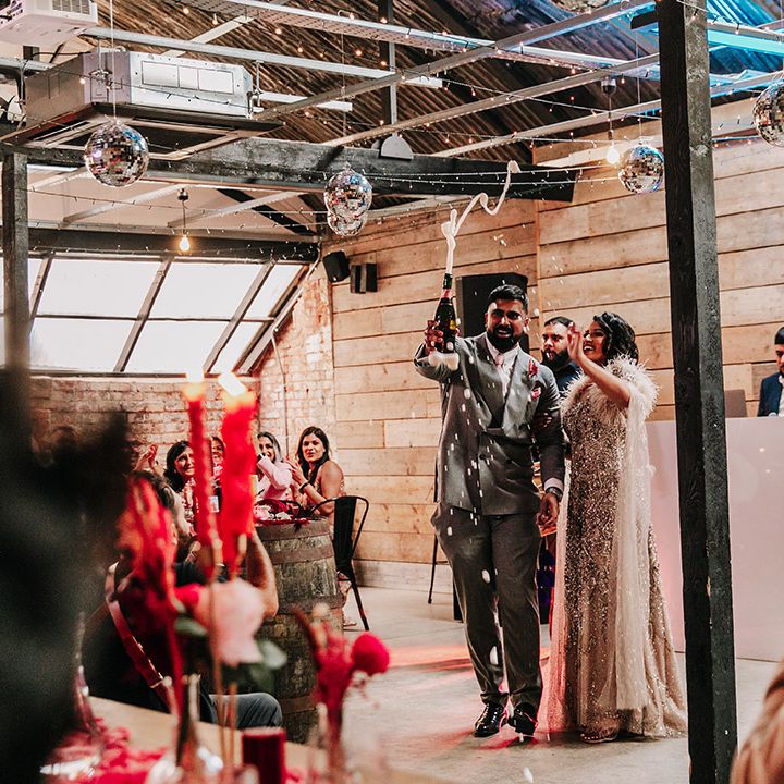 bride-and-groom-pop-champagne-at-wedding